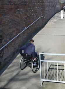Pushing wheelchair up a ramp