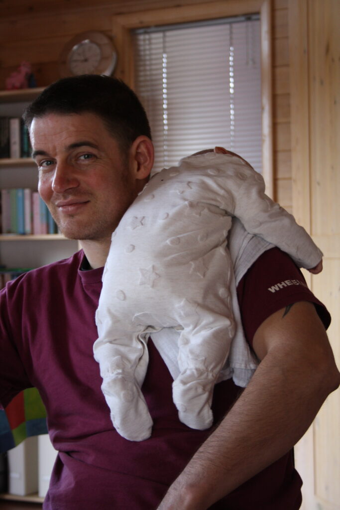 Hanging in there... wheelchair user carrying baby on shoulder