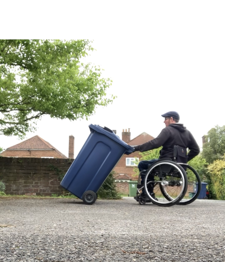 Wheelchair user brining bin in